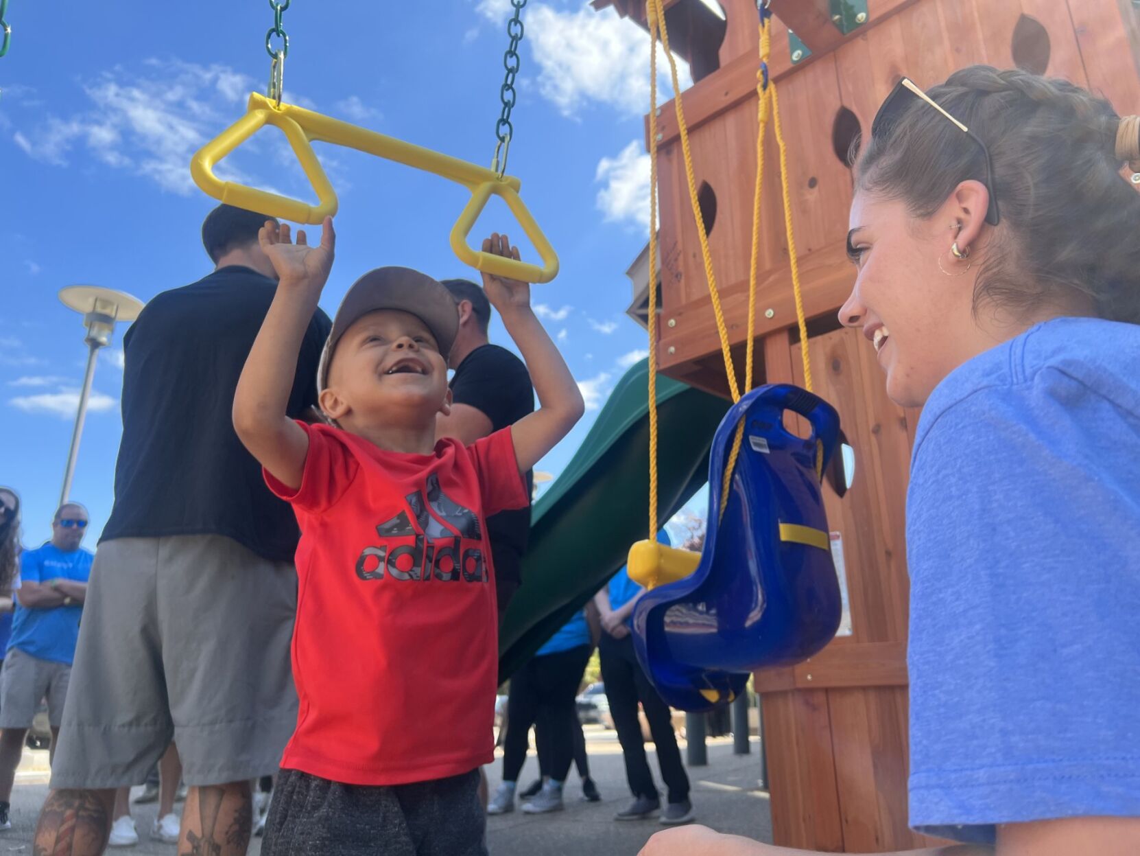 Jaxon Gass plays on swingset
